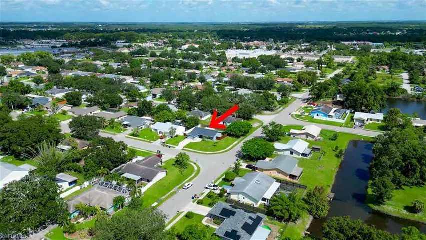 Birds eye view of property with a water view