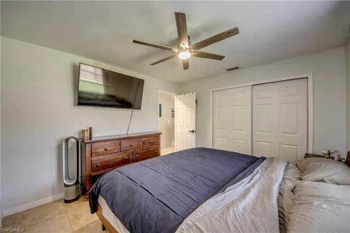 Tiled bedroom featuring a closet and ceiling fan