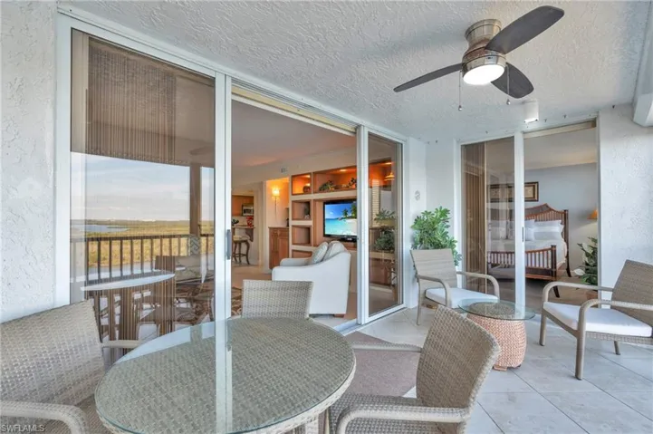 Sunroom with ceiling fan / virtually enhanced image