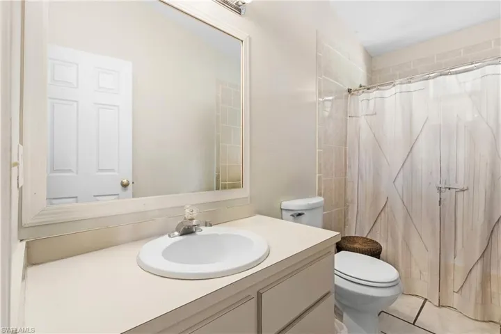 Full bathroom with vanity and curtained shower