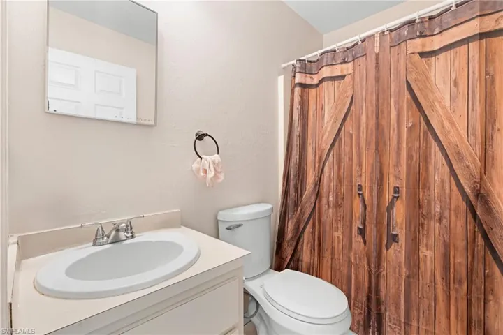 Bathroom with vanity and curtained shower