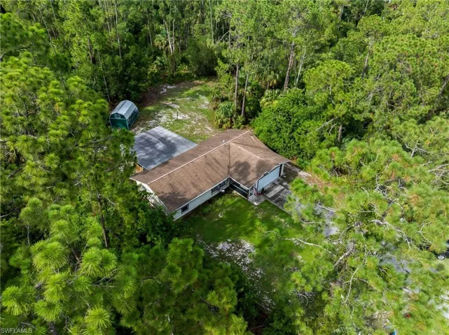 View of subject property featuring a forest