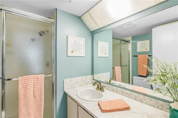 Full bath with vanity and a shower stall