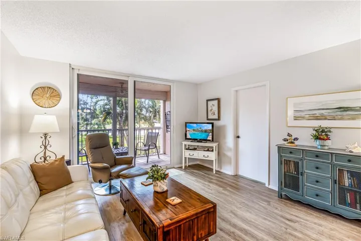 Light and bright living area featuring LVP flooring and views