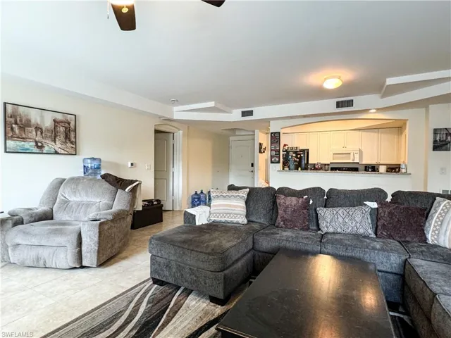 Living room featuring ceiling fan and light tile patterned flooring