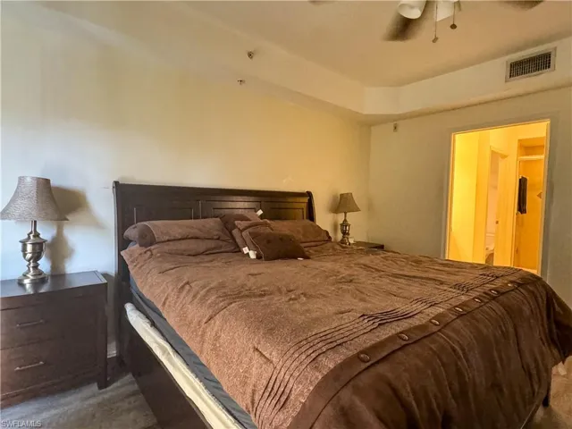 Carpeted bedroom with ceiling fan