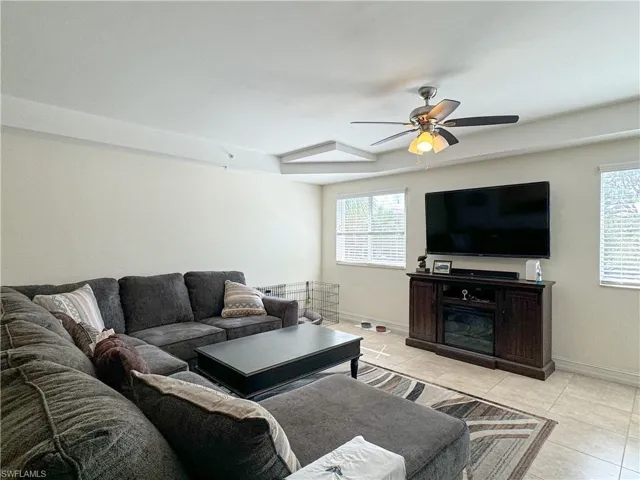 Tiled living room featuring ceiling fan