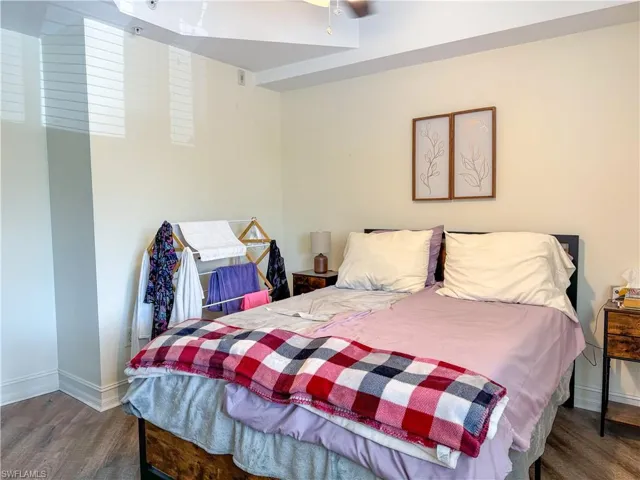 Bedroom featuring dark wood-type flooring and ceiling fan