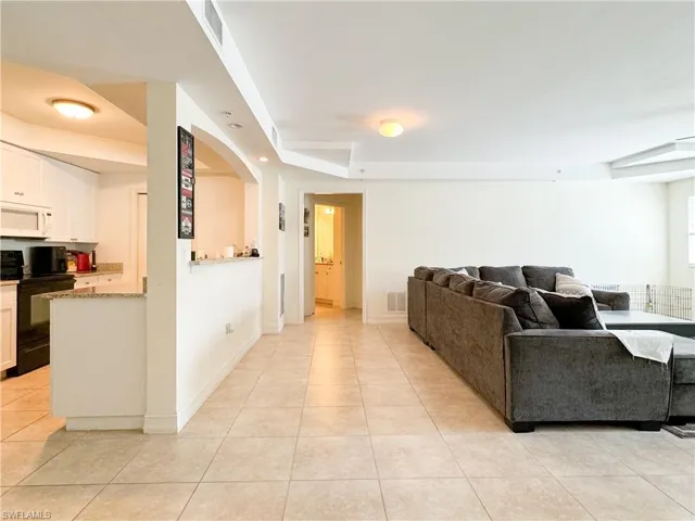 Living room with light tile patterned floors