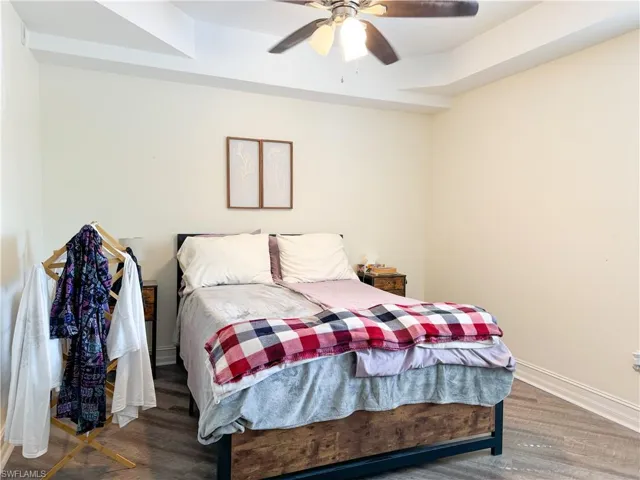 Bedroom featuring ceiling fan and wood-type flooring