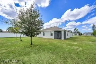 Rear view of house with a yard