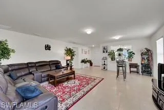 Living room with light tile patterned flooring