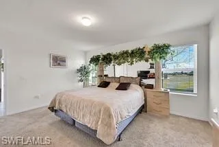 Bedroom featuring light carpet