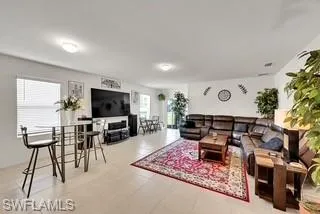 Living area featuring light tile patterned flooring