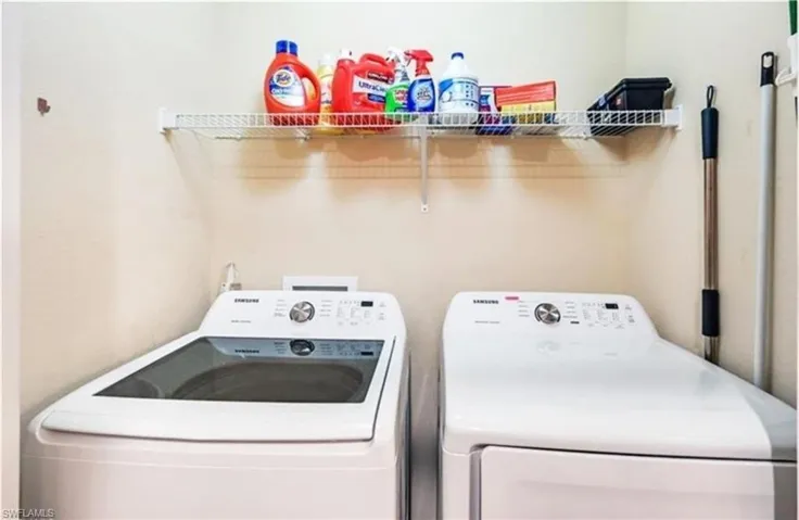 Laundry area featuring washing machine and clothes dryer