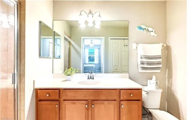 Full bathroom featuring vanity, ensuite bathroom, a shower stall, and a chandelier