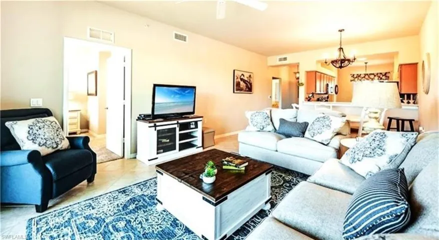 Living area featuring a chandelier and light tile patterned flooring