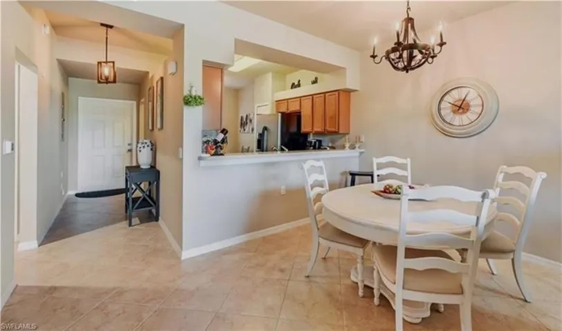 Dining area featuring a chandelier and light tile patterned flooring