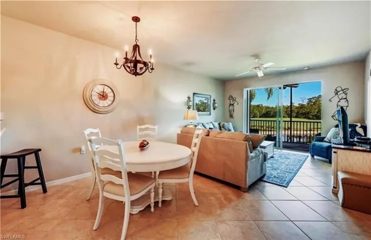Dining area with a chandelier, a ceiling fan, and light tile patterned floors