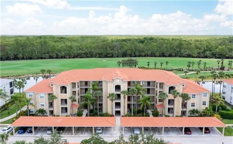 Drone / aerial view of apartment complex and a large body of water