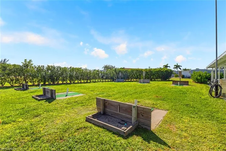 View of property's community with a patio and a yard