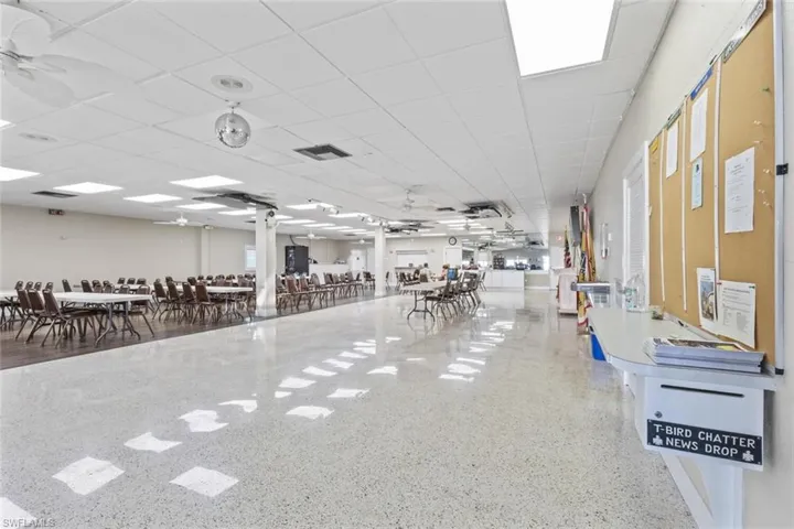 Miscellaneous room with ceiling fan and a drop ceiling