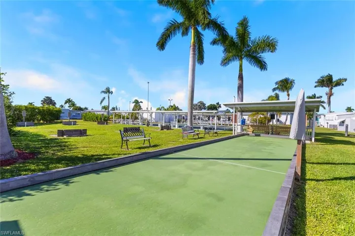 View of home's community featuring a game area and a yard