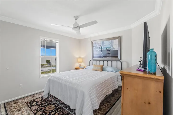 Bedroom featuring ornamental molding and a ceiling fan