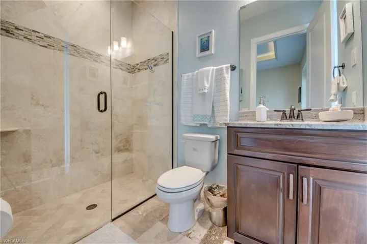 Full bathroom featuring a stall shower and vanity
