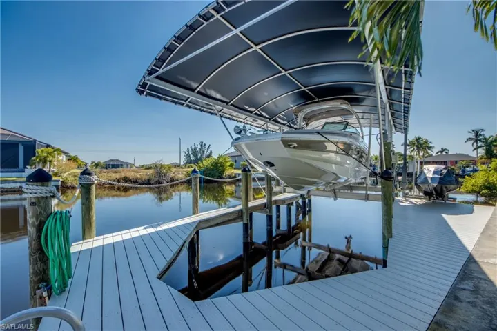 Dock featuring boat lift and a water view