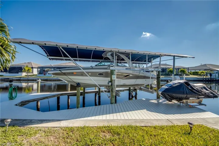Dock area with boat lift and a water view