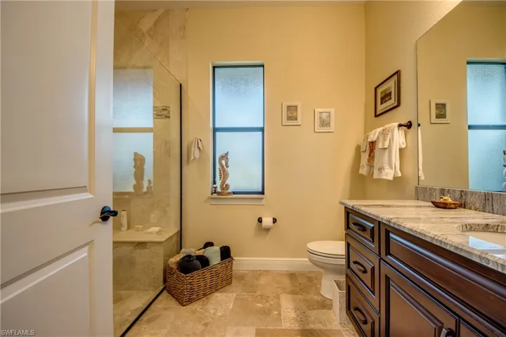 Full bathroom featuring vanity and a shower stall