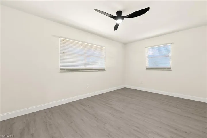 Spare room with wood finished floors and a ceiling fan