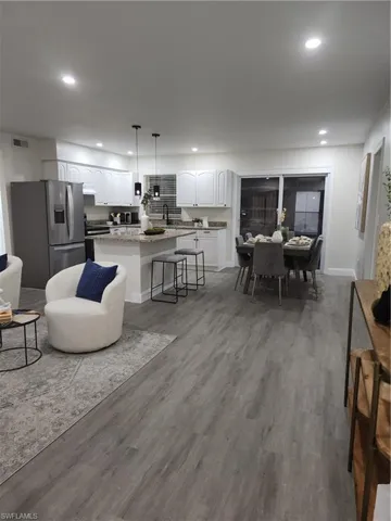 Living room with wood finished floors and recessed lighting