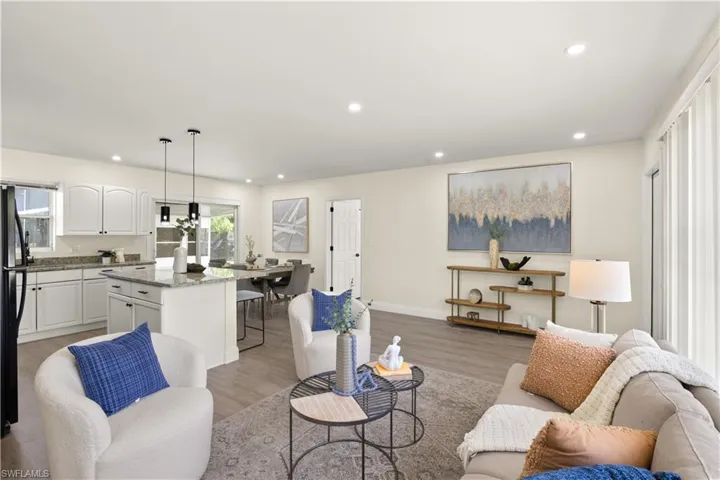 Living area with plenty of natural light, light wood-style floors, and recessed lighting