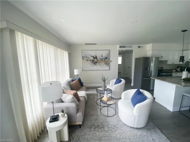 Living room featuring baseboards and light wood-style floors