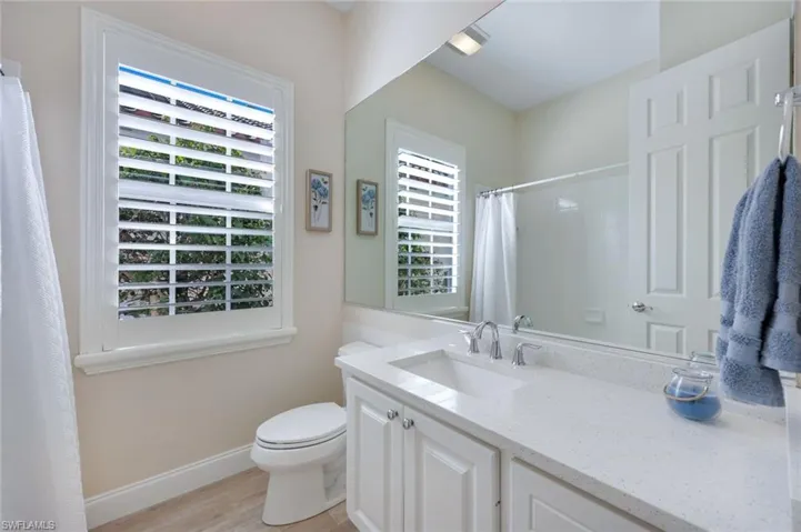 Bathroom vanity with a white countertop and integrated sink