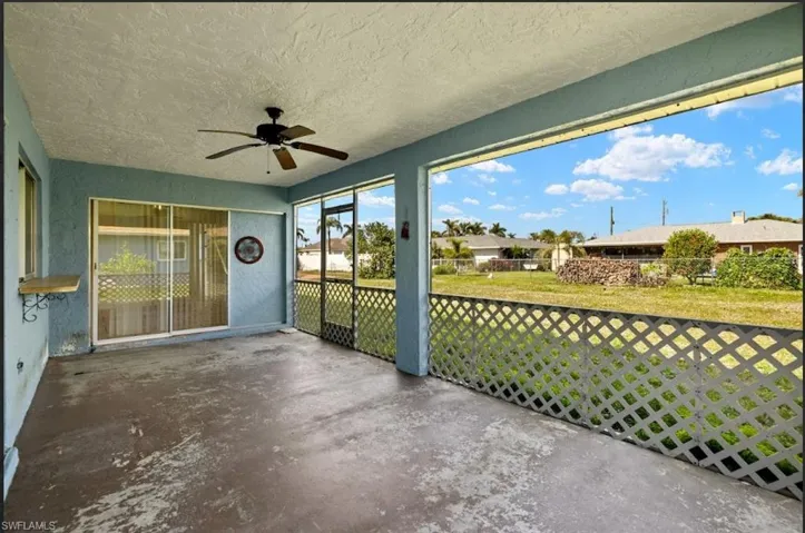 Unfurnished sunroom featuring ceiling fan