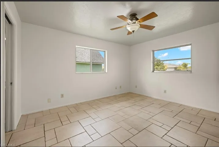 Empty room featuring a wealth of natural light and ceiling fan