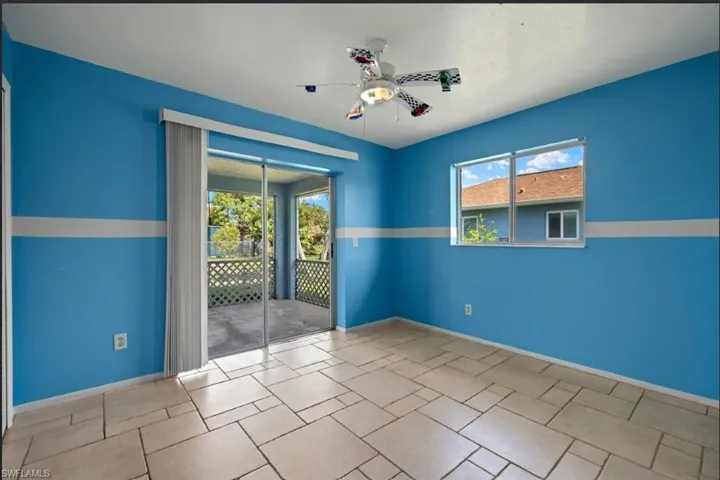 Spare room featuring plenty of natural light and ceiling fan