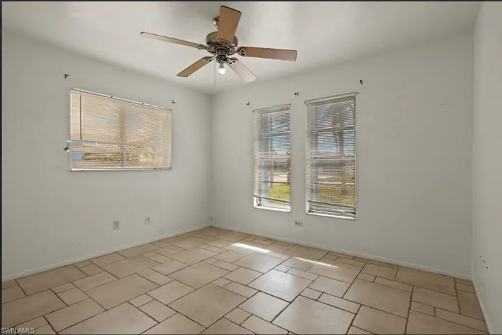 Empty room featuring ceiling fan
