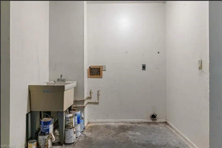 Clothes washing area featuring hookup for a washing machine and hookup for an electric dryer
