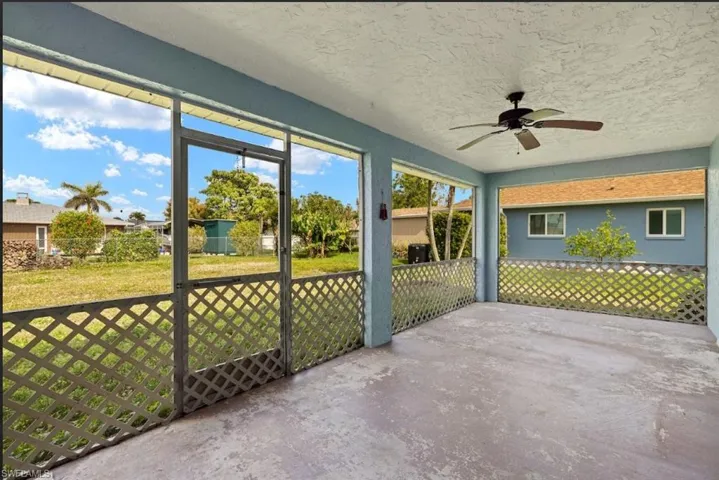 Unfurnished sunroom featuring ceiling fan