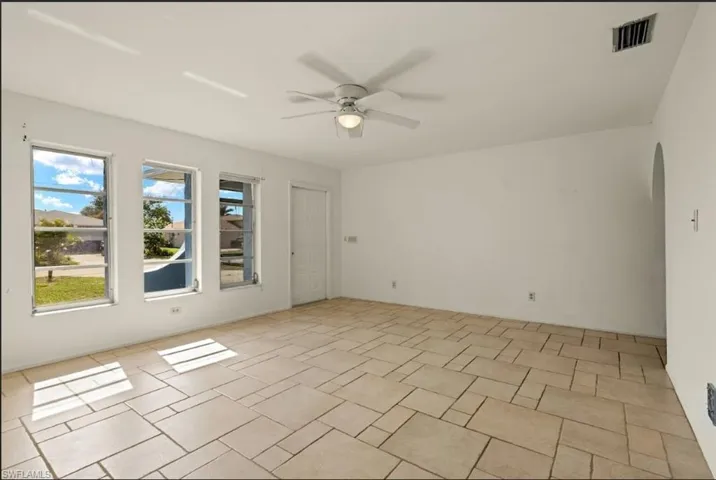 Unfurnished room featuring ceiling fan
