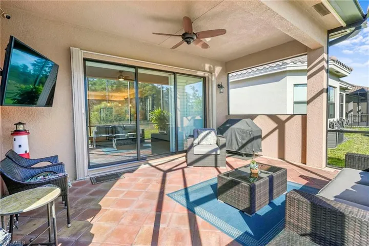 View of patio featuring a ceiling fan, outdoor seating, and a grill