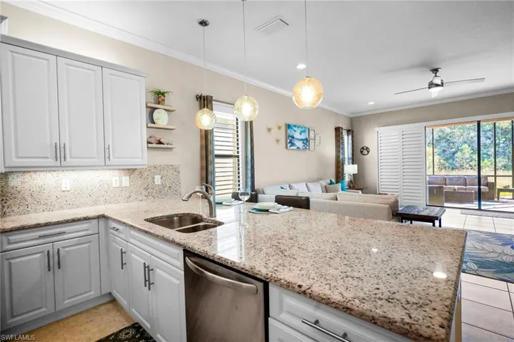 Kitchen with light stone countertops, a peninsula, dishwasher, decorative backsplash, and open shelves