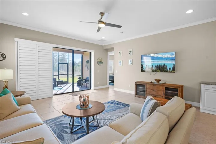 Living area featuring light tile patterned floors, crown molding, a ceiling fan, and recessed lighting