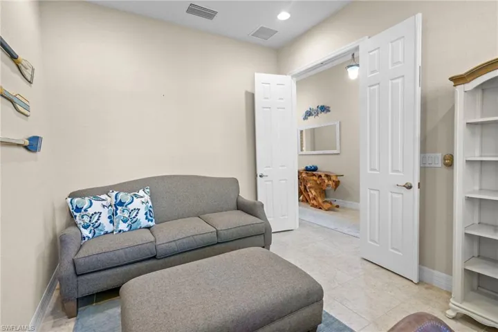 Sitting room featuring light tile patterned floors and recessed lighting