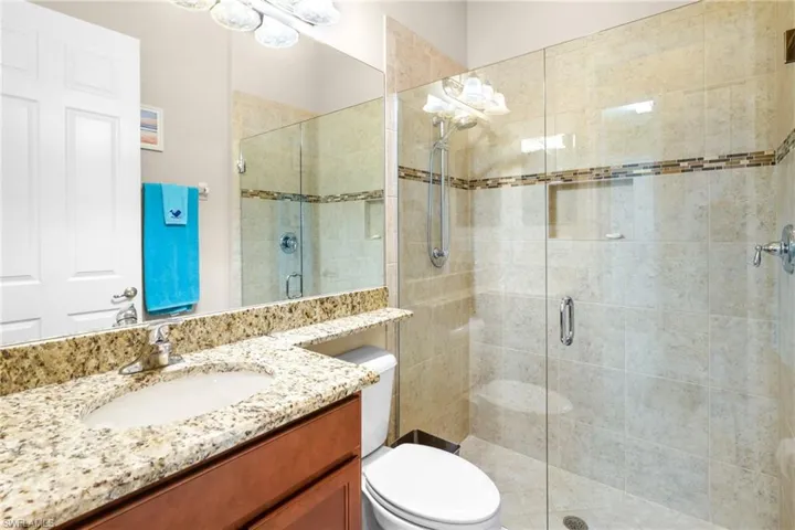 Full bath featuring vanity and a stall shower