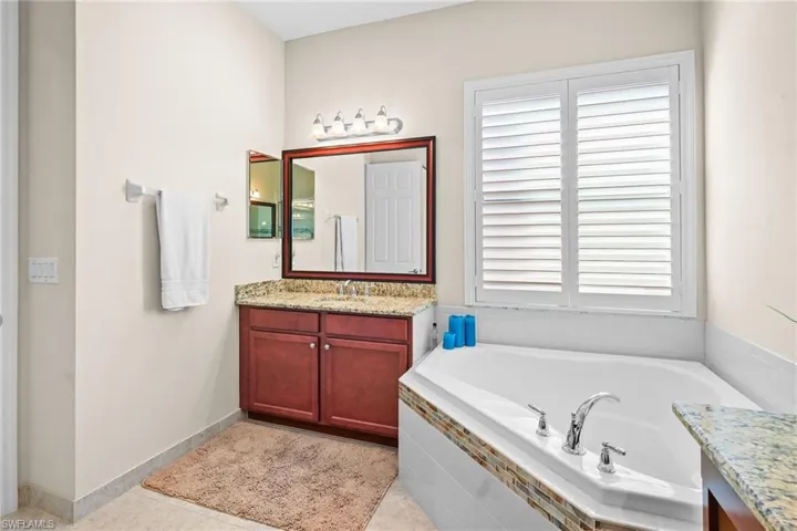Bathroom featuring vanity and a bath